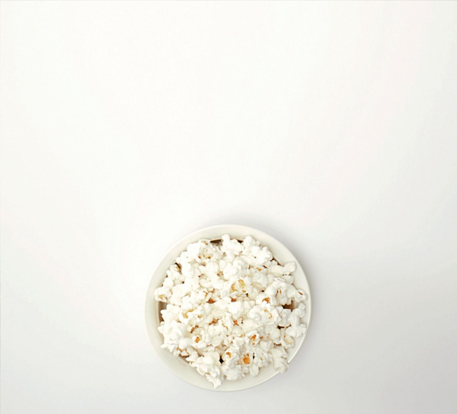 Kitchen Table CEOs Blog - Family-friendly movies for the entire family - family movie night- kitchen table ceos- by tracy smith - bowl of popcorn on a white table