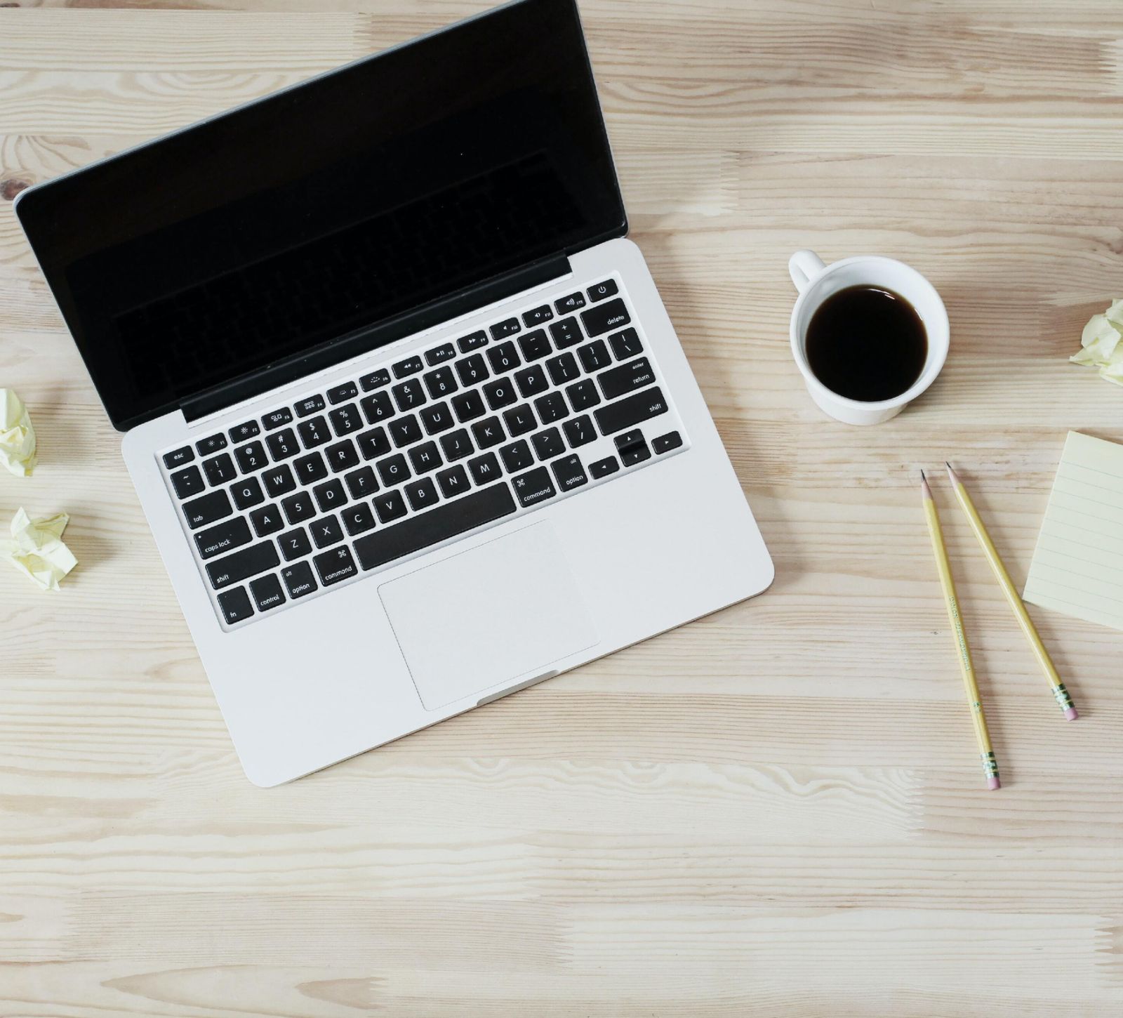 Kitchen Table CEOs Blog - What to ask your Web Developer before you hire them - laptop on a desk with coffee and pencils - Lauren Mancke Unsplash